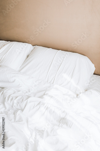 Crisp with bedsheets in a beige bedroom