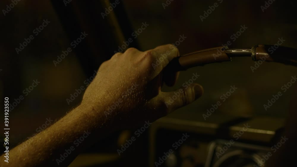 Close-Up of hand on steering wheel driving at night. Close-Up of hand on steering wheel driving at night.