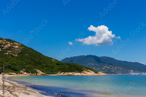 Coastal scenery under blue sky and white clouds