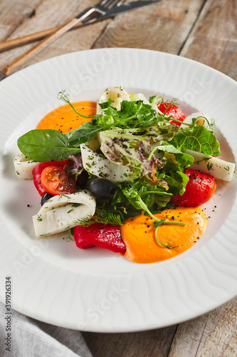 Roasted pepper salad with calamari and fresh greens
