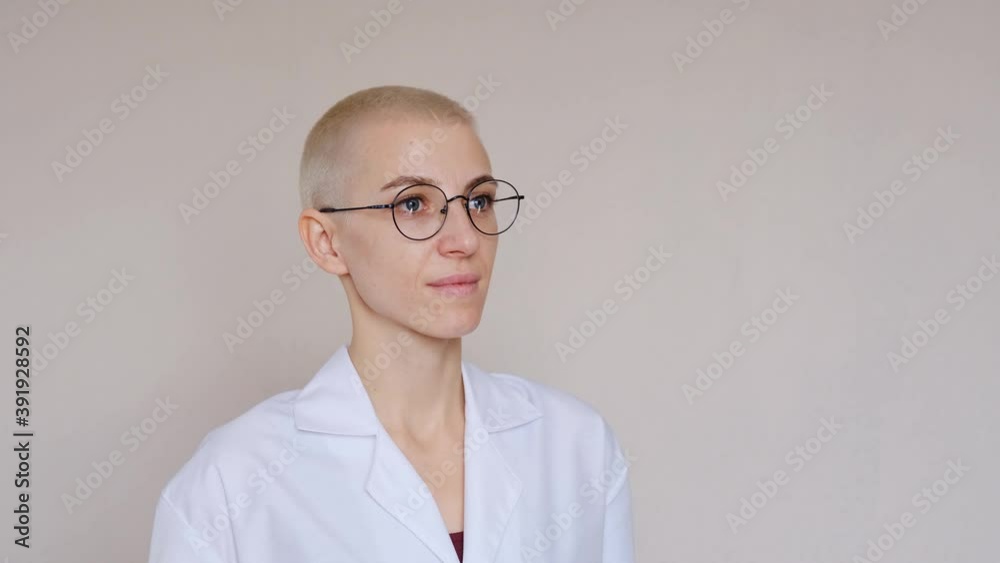 Doctor in a white medical jacket looks directly at the camera.