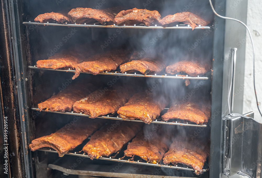 smoke rising around a slow cooked beef brisket on a smoker barbecue grilling concept smoke rising around a slow cooked beef brisket on a smoker barbecue grilling concept