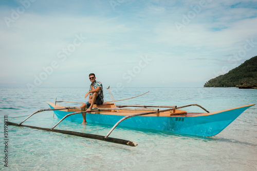 Guy on a fishing boat in the Philippines around the ocean