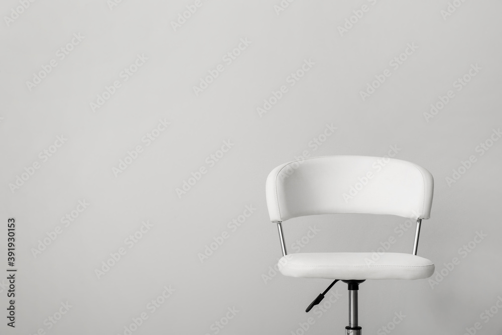Comfortable office chair on light background. Space for text Comfortable office chair on light background. Space for text