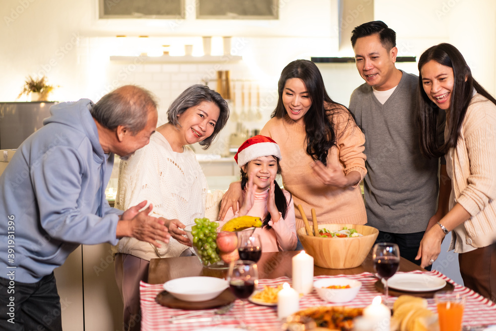 Asian big family sing a song while preparing foods for Christmas party Asian big family sing a song while preparing foods for Christmas party