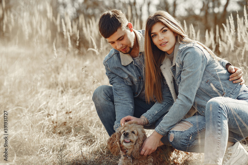 Woman in a jeans clothes. Couple in a spring forest. People with a cute dog.