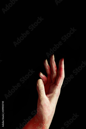 A beautiful horror red female hand stretches your product on a black isolated background, concept art 