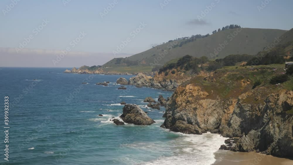 Rocky Coast and beaches of Big Sur California State Park hit by ocean waves, Handheld wide shot
