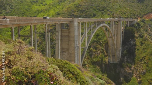 Bixby Creek Bridge at Big Sur California State Park with car traffic, Slow Pan Right Shot