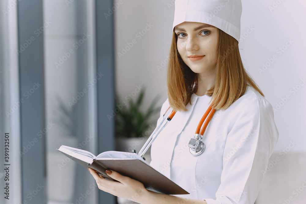 Smiling medical doctor woman with stethoscope. Isolated over white background. Image of an enthusiastic intern looking at camera Smiling medical doctor woman with stethoscope. Isolated over white background. Image of an enthusiastic intern looking at camera