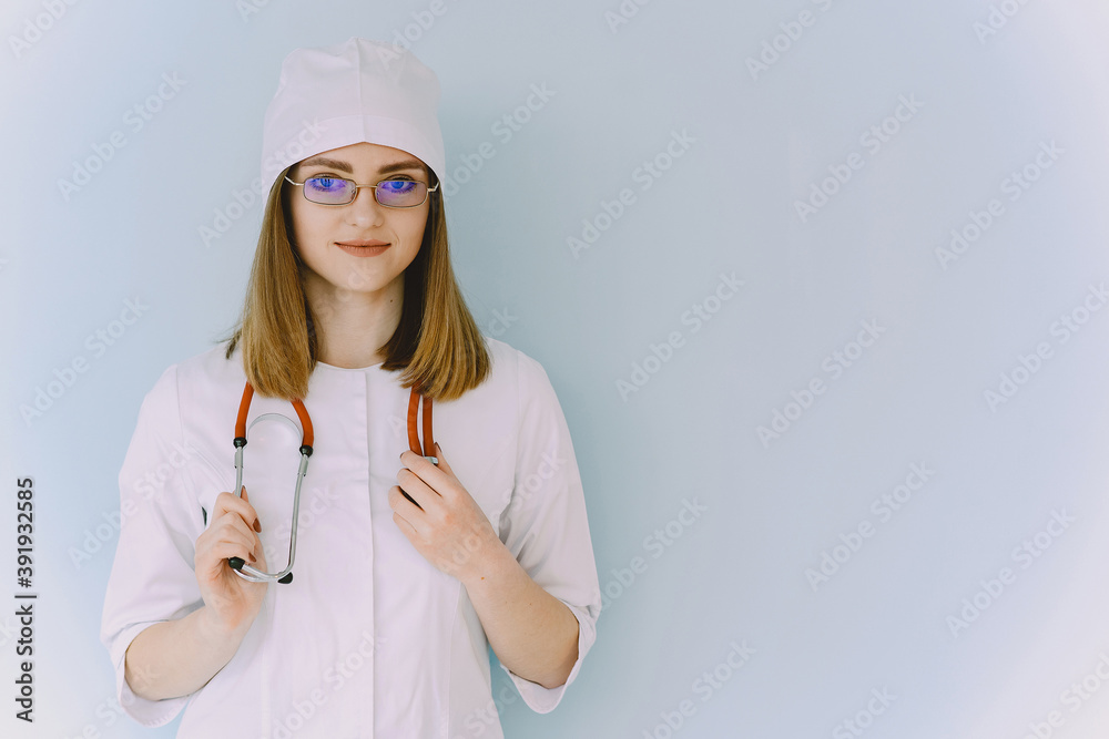 Smiling medical doctor woman with stethoscope. Isolated over white background. Image of an enthusiastic intern looking at camera