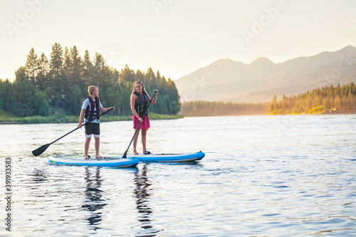 Family Paddle boarding together on a Beautiful Mountain Lake © Brocreative