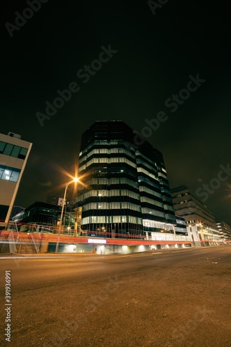 long exposure of traffic at night in front of glass building in St. John's, newfoundland, canada © Erik