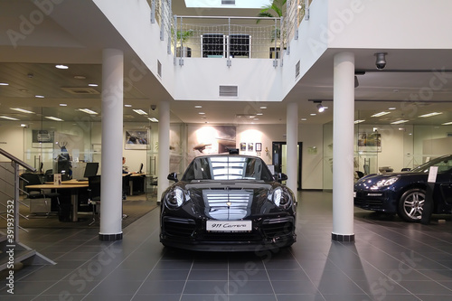 Moscow. February 2018. Black Porsche 911 991 Carrera  at dealer showroom. Headlights and aerodynamic turbo packed Front view