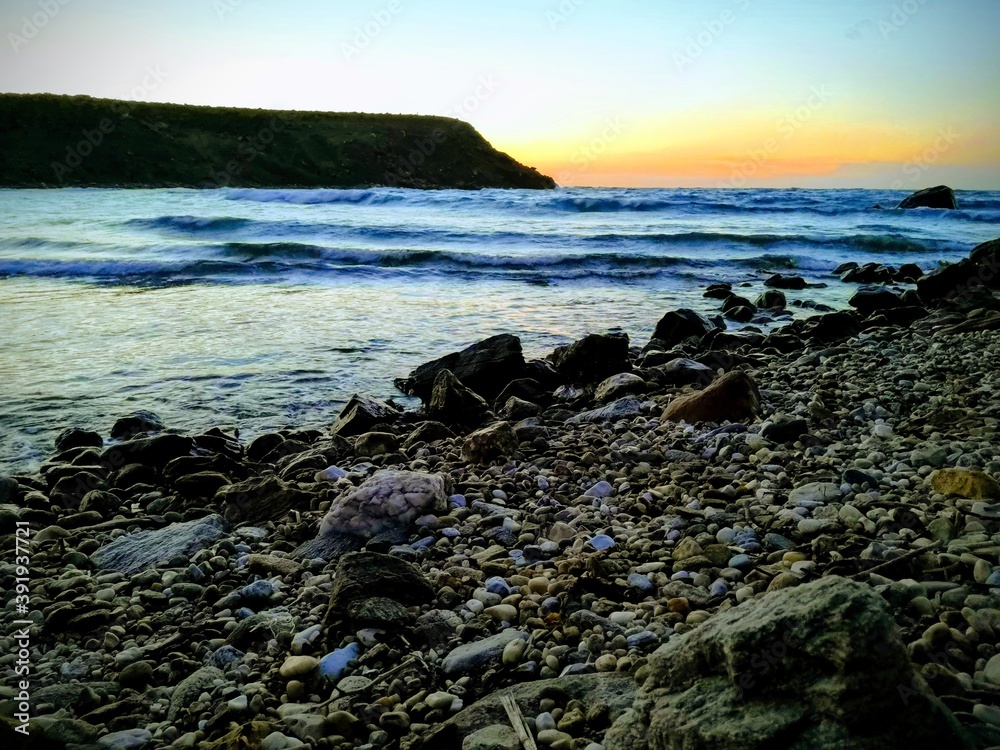 beautiful sunset panorama with rocks at the beach on the island of Naxos, Greece