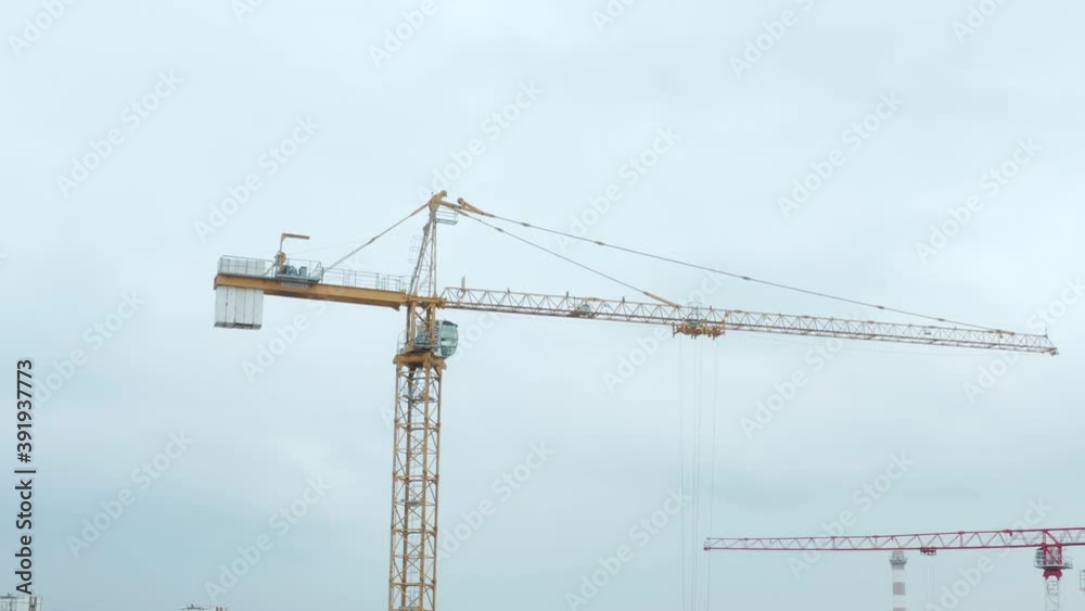 High crane works on building site. Aerial drone view of construction site crane over city High crane works on building site. Aerial drone view of construction site crane over city