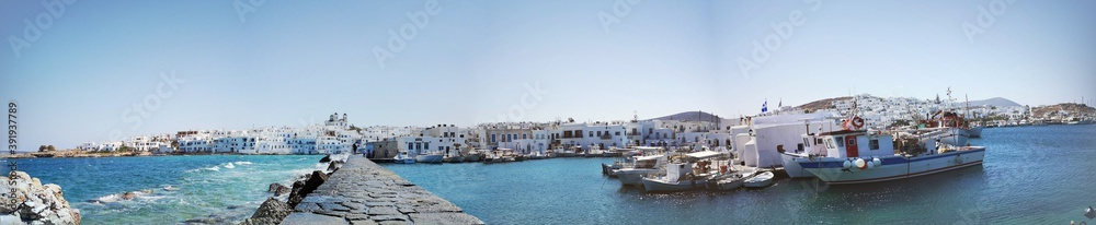 beautiful panorama of the village of Naousa with coast and traditional historical white Greek buildings on the island of Paros, Greece