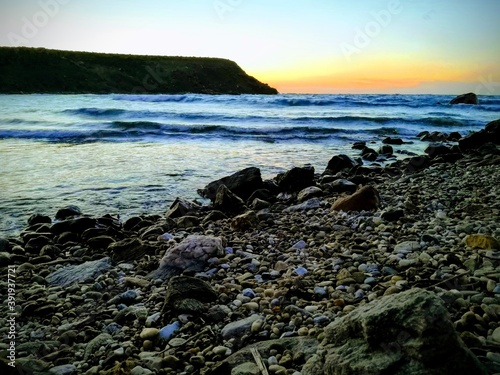 Obraz na płótnie beautiful sunset panorama with rocks at the beach on the island of Naxos, Greece w salonie