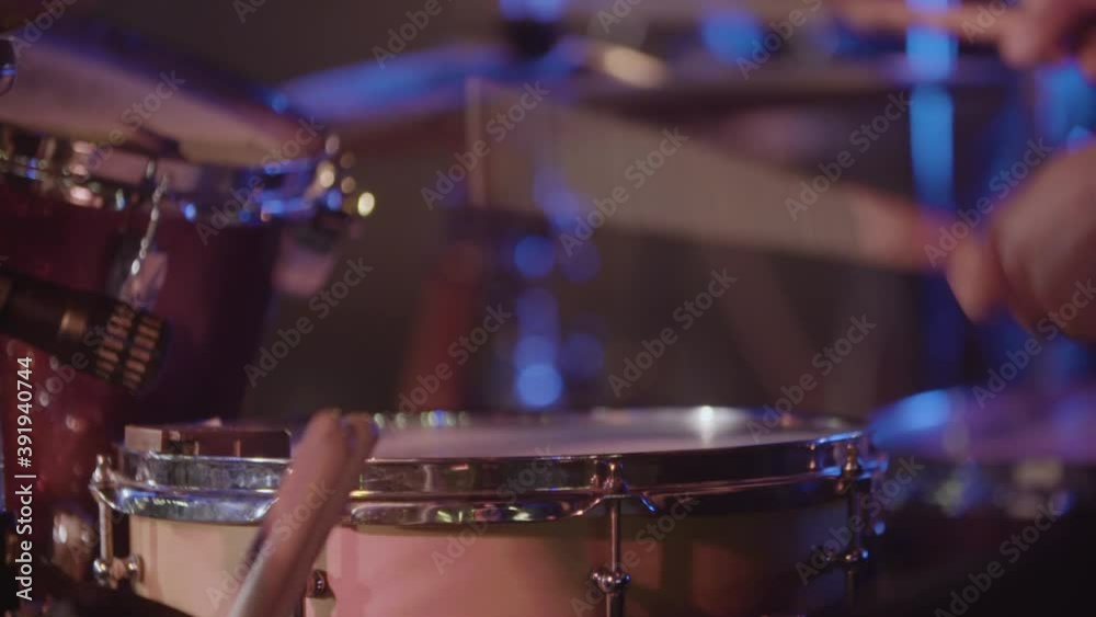 Slow motion close up of a drum player's hands during concert