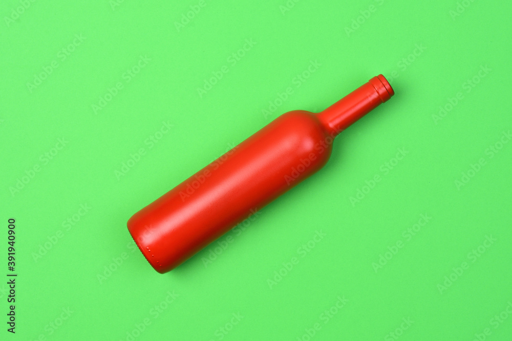 red glass bottle on green background red glass bottle on green background