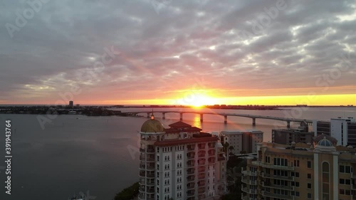 Bay area of Sarasota, Florida during sunset. Drone footage of Golden Gate Point and the Ringling bridge with the sunset in the background. Shot in 24 fps. photo