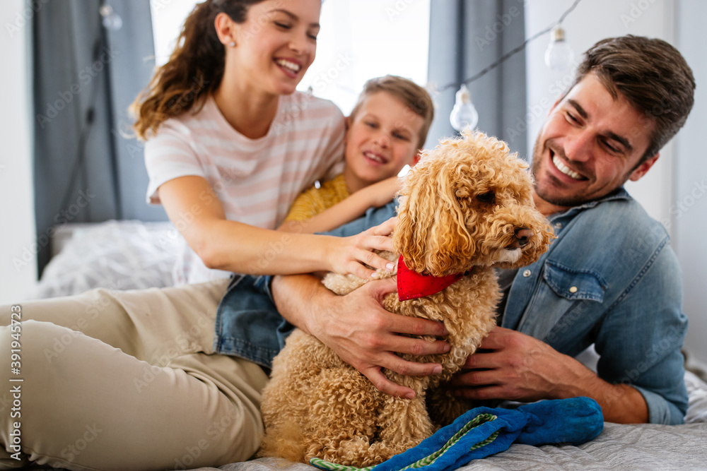 Happy family having fun time, playing together at home with dog Happy family having fun time, playing together at home with dog