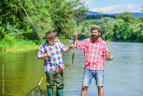 Bearded men catching fish. Summer vacation. Fisherman with fishing rod. Activity and hobby. Fishing freshwater lake pond river. Mature man with friend fishing. It is not sport, it is obsession