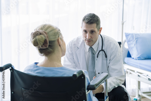 Doctor talking patient on wheelchair in hospital Medical healthcare job  or hospital business concept.