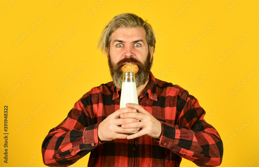 Cookies and cream in fresh milk glass. happy farmer eat cookie dessert. bearded man drink useful milk with pastry. Gingerbread cookie in a hot cup of milk. American famous snack Cookies and cream in fresh milk glass. happy farmer eat cookie dessert. bearded man drink useful milk with pastry. Gingerbread cookie in a hot cup of milk. American famous snack