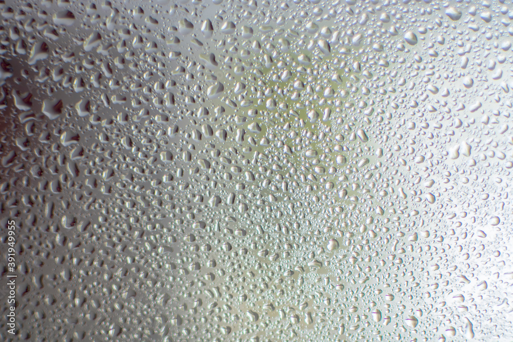 Water drops on glass. Back light. Photo Taken with selective focus and noise effect. Water drops on glass. Back light. Photo Taken with selective focus and noise effect.