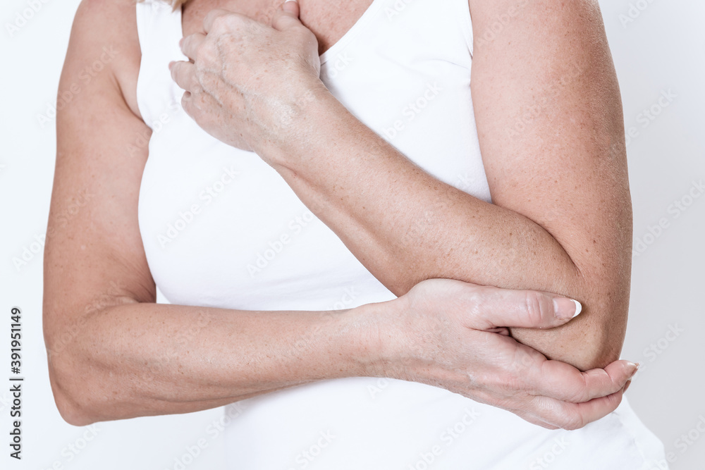 Fototapeta premium A woman has a pain in her arm.