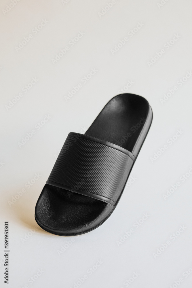 Black rubber flip flops slipper on gray Black rubber flip flops slipper on gray