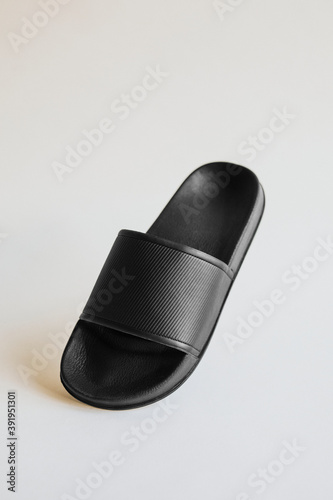 Black rubber flip flops slipper on gray