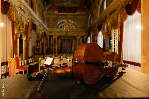 wooden luxury violin musical instrument lies on a black background in the middle of the music hall