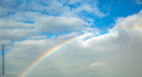 Front view of rainbow background on a cloudy sky © bahadirbermekphoto