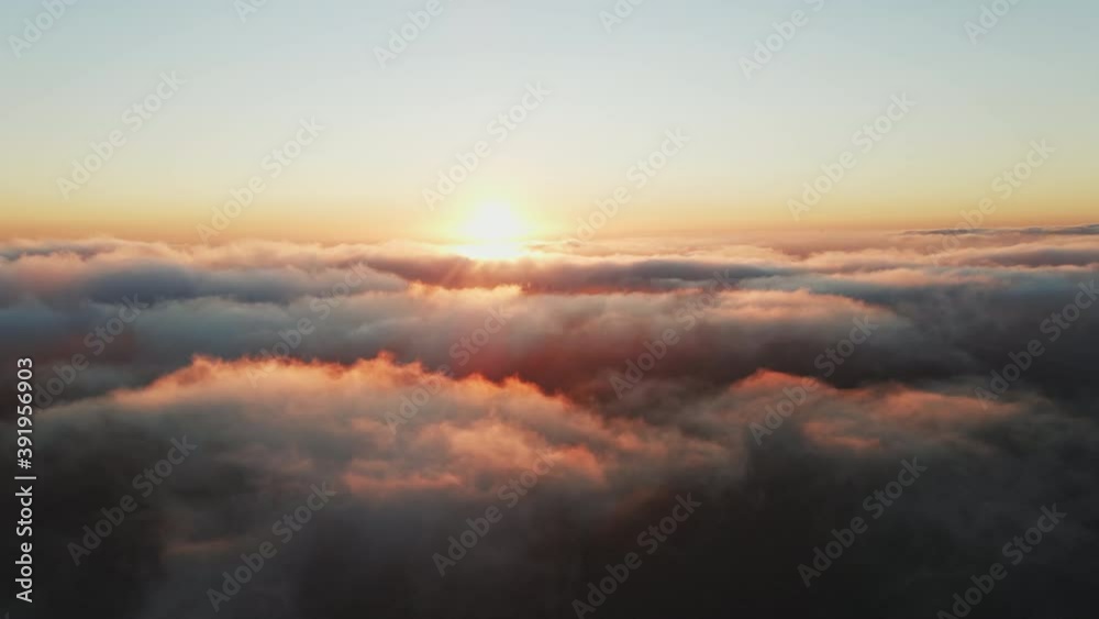Moving white clouds blue sky scenic aerial view sunset golden sun summer. Drone flies high back in blue sky through fluffy clouds in evening. Sun is hidden behind clouds at fog. Relax. Nature Moving white clouds blue sky scenic aerial view sunset golden sun summer. Drone flies high back in blue sky through fluffy clouds in evening. Sun is hidden behind clouds at fog. Relax. Nature