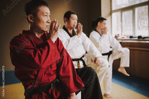 People stand in kimono and work together in hall.