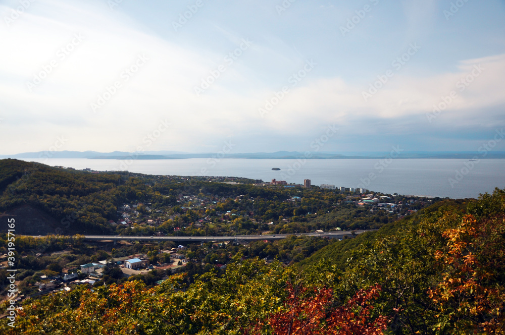 Far East of Russia, Vladivostok city. Sea of Japan, hills, buildings, roads, greenery. Panoramic view from above.