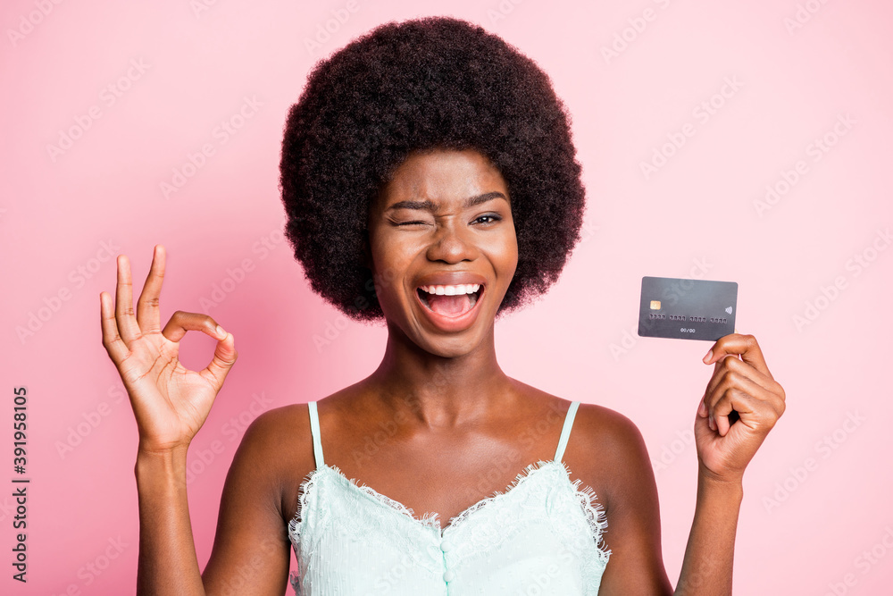 Photo of brunette trendy stylish girl wink show okay sign hold credit card wear tank-top promotion isolated on pink color background Photo of brunette trendy stylish girl wink show okay sign hold credit card wear tank-top promotion isolated on pink color background