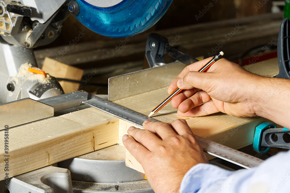 Carpenter work with circular saw for cutting wood bar, the man sawed bars, construction and home renovation. Carpenter work concept Carpenter work with circular saw for cutting wood bar, the man sawed bars, construction and home renovation. Carpenter work concept