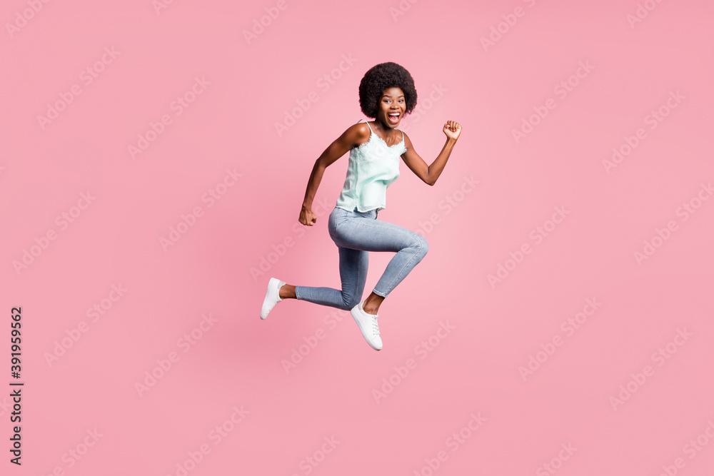 Full body photo of attractive wavy hairdo lady fists up jump open mouth blue singlet isolated on pink color background Full body photo of attractive wavy hairdo lady fists up jump open mouth blue singlet isolated on pink color background