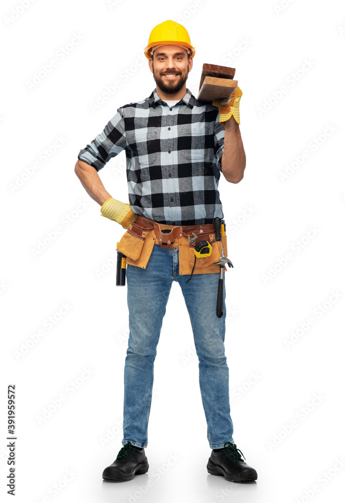profession, construction and building - happy smiling male worker or builder in helmet with boards over white background
