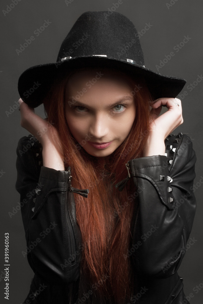 young ginger rock style woman in black hat and leather jacket young ginger rock style woman in black hat and leather jacket