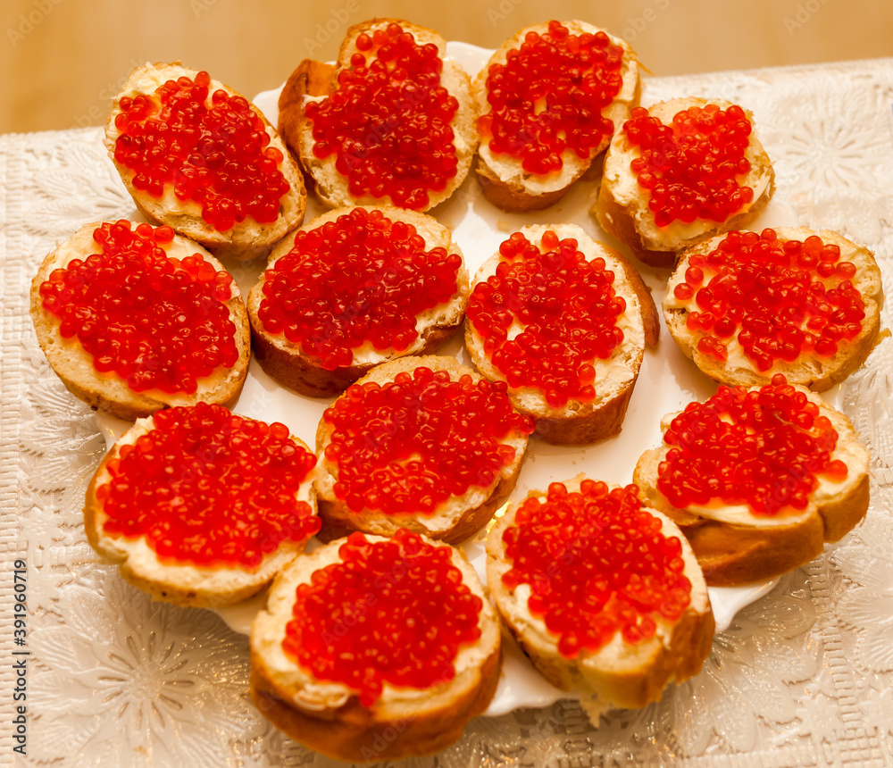Sandwiches with red caviar on a plate