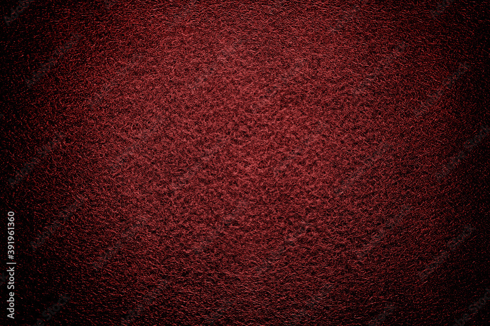 Abstract background of intense black gold orange felt material with