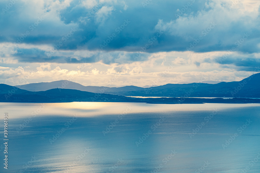 Fototapeta premium picturesque view on sea coastline and cloudy sunset sky