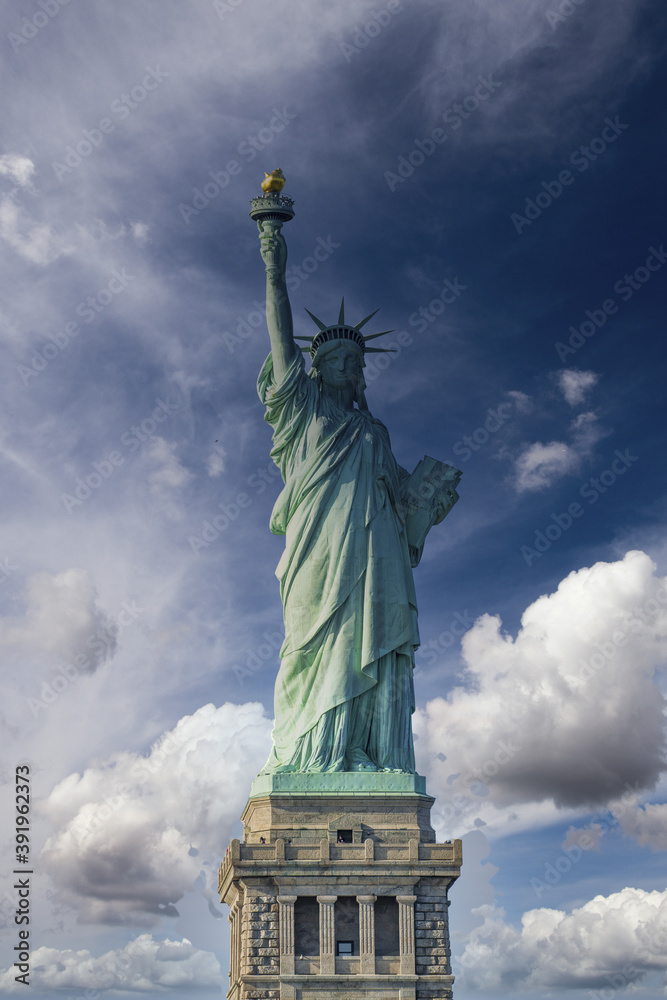 Fototapeta premium New York City, The Statue of Liberty at sunset with a beautiful colorful sky