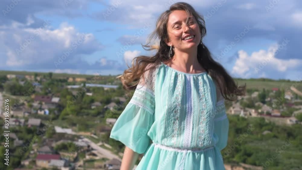Happy woman wearing traditional moldovan dress dancing at Orheiul Vechi in Moldova Happy woman wearing traditional moldovan dress dancing at Orheiul Vechi in Moldova