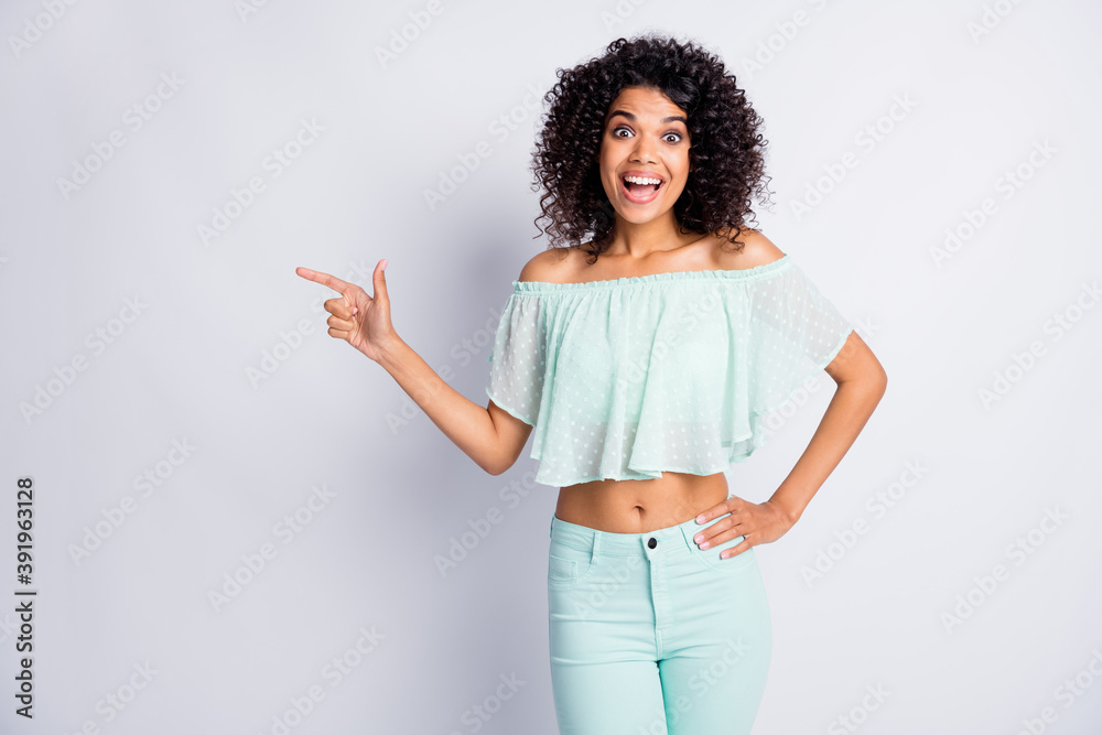 Photo portrait of excited woman pointing finger at blank space isolated on white colored background