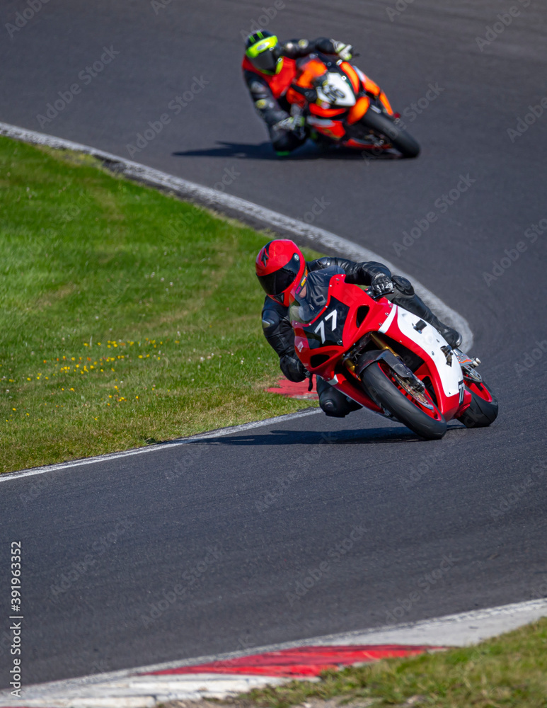 A shot of two racing bikes cornering on a track.